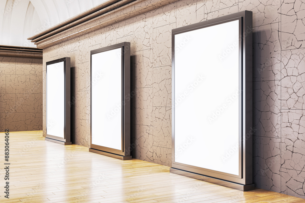 Aufkleber three vertical blank posters in a gallery with a wood floor and textured walls, a concept of an art 