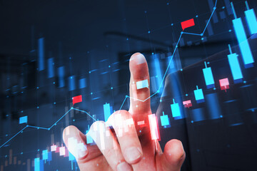 A person's hand interacting with a digital stock market chart on a dark blue background, symbolizing financial analysis