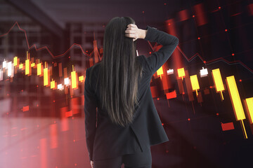 A businesswoman analyzing financial charts on a digital interface, set against a dark office background, illustrating the concept of market analysis