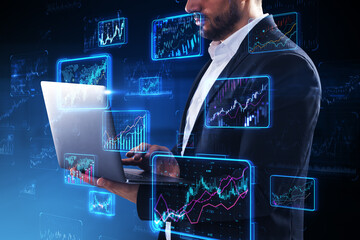 A man using a laptop with futuristic digital stock market data overlay, against a dark background, concept of finance analytics
