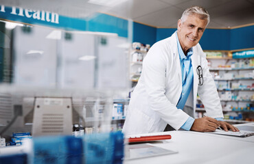 Portrait, paperwork and mature pharmacist with prescription, drugs or healthcare in pharmacy clinic. Checklist, medical note and proud chemist writing note by counter of medication store dispensary