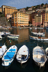 Small boats and colorful buildings around the port of Camogli on an October afternoon (Liguria, Italy)