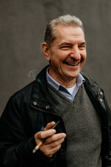 Elderly Man Smiling With Cigarette in Hand, Outdoor Portrait