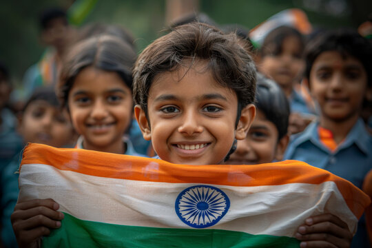 Proud and happy Indian children, holding an Indian tricolour flag, celebrates Independence Day	