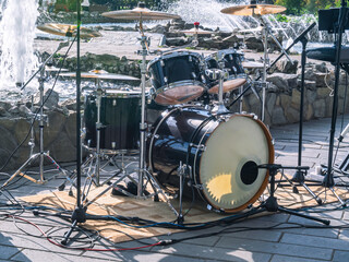 A set of percussion instruments used by one drummer. The drum kit at the fountain. Musical...