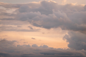 Clear blue sky with glowing pink and golden cumulus clouds after storm at sunset. Dramatic cloudscape. Concept art, meteorology, heaven, hope, peace, graphic resources, picturesque panoramic scenery