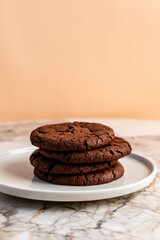 Stack of three dark chocolate chip cookies