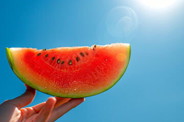 hand holding watermelon under the sun 