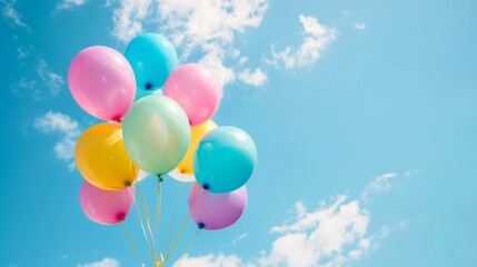 Obraz premium colorful helium balloons floating against blue sky joyful celebration background