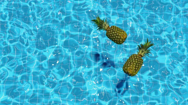 Loop two pineapples floating in a pool in summer, top view