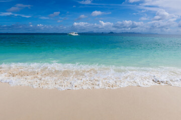 Beautiful beach with white sand, turquoise ocean water and blue sky with clouds in sunny day. Panoramic view. Natural background for summer vacation. Empty sea with blue sky on summer at Thailand.