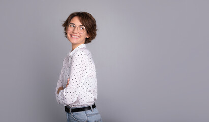 Young confident employee business corporate lawyer woman of in smart formal shirt and eyeglasses. Work in office. Female with stylish hairstyle isolated on grey background studio.