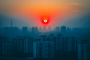 Obraz premium You can see the house and the sun in the foggy background. Atmospheric distortion, hot air distortion, heat distortion, air refraction. Soft selective focus. Artificially created grain for the picture