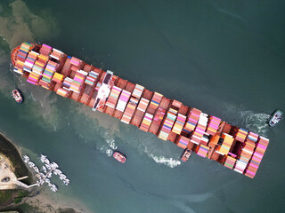 Fototapeta premium Aerial top view container ship full load container for logistics import, export, shipping or transportation concept background.