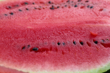 
close-up of a slice of red watermelon with seeds