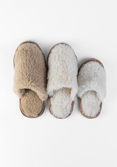 A set of slippers made of natural fur on a white background of different sizes and colors.