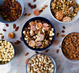 A deluxe display of various mixed nuts in different bowls, creating a Christmas atmosphere.