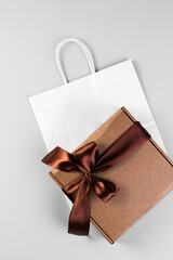 Gift box with bow and package on a gray background. Gift wrap.
