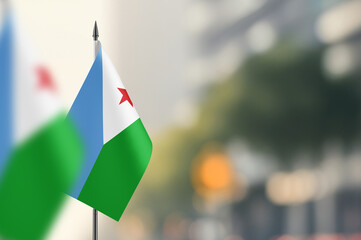 Small flags of Djibouti on a blurred background