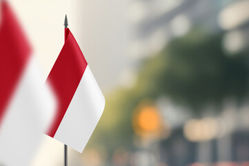 Small flags of Monaco on a blurred background
