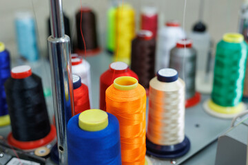 Set of multi colored threads of modern electronic professional embroidery machine.