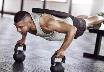 Power, push ups and man in gym with kettlebell for strength training, endurance challenge or muscle growth. Exercise, athlete and person with weights for bodybuilding, performance workout or fitness