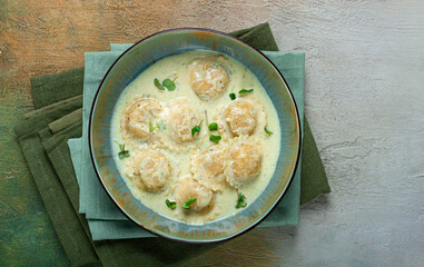 ravioli in cream sauce, spices and herbs, top view, no people,