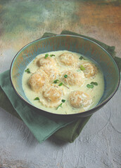 ravioli in cream sauce, spices and herbs, top view, no people,