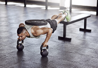 Exercise, push ups and man in gym with kettlebell for strength training, endurance challenge or muscle growth. Power, athlete and person with weights for bodybuilding, performance workout or fitness