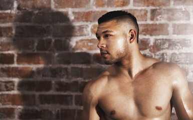 Fototapeta premium Shirtless, thinking and man in gym for fitness, wellness and health with workout routine for muscular body. Training center, male bodybuilder and confidence for exercise, commitment and wellbeing