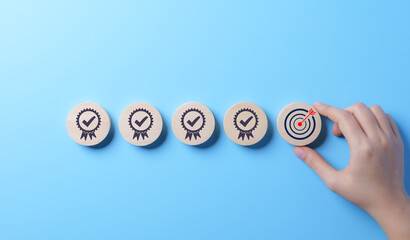 Standard Quality Control and Certification Concept. Hand places wooden block with target icon among blocks with check marks, standard quality control, certification, assurance for automation processes