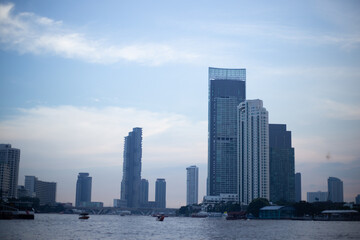 Naklejka premium blue skyscape background with cloud and silhouette city town building in evening of the day sunrise dusk day time cityscape panorama
