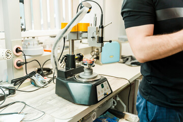 Dental laboratory machine with technician operating equipment