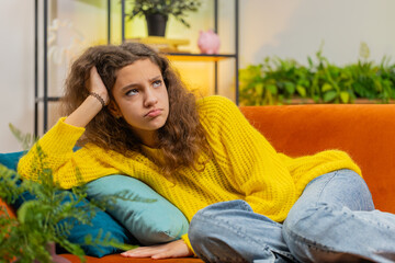 Sad lonely teenager child girl at home looks pensive thinks over life concerns, study test exam...