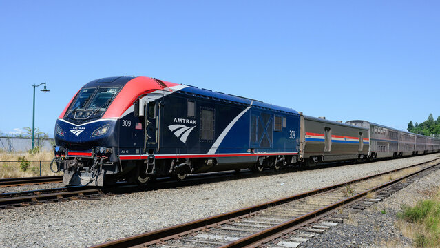 Mukilteo, WA, USA - July 11, 2024; Amtrak Empire Builder train with modern ALC-42 locomotive in summer with logo