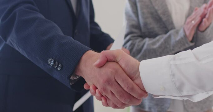 Close up of handshake, male hands shaking as good symbol of effective business negotiations, making agreement, greeting new partner, showing mutual respect in relationships, applauding, congratulating