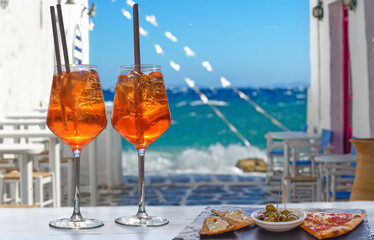 two aperol spritz with appetizer in a bar on the Greek island of Mykonos