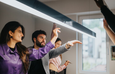 Energetic business team engaged in a strategic meeting in a brightly lit office, brainstorming...