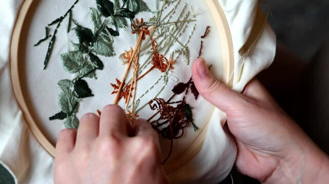 Close up of Woman's hands working on embroidery with thread and needle