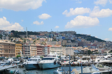 Boats in the marina. Beautiful white yachts parked on the sea coast on the mountains and Vesuvius volcano background, Naples, Italy