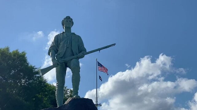 Minuteman Statue and US Flag Under Blue Sky, Lexington, MA, USA