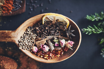 Herbs, kitchen and spices in top view on background for healthy, natural or organic food. Table, dry lemon and peppercorn above for seasoning, condiments and cooking powder with ingredients closeup