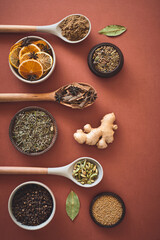 Healthy, spices and ingredients with ginger, herbs and wooden spoons on studio background. Empty, kitchen utensils and mockup space with seasoning, variety and organic with fine dining and flavour