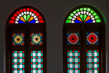 Colorful stained glass window in the ancient Persian Aghazadeh mansion in Abarkuh, Yazd, Iran with...