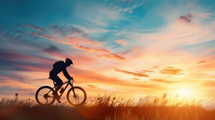 A man is riding a bicycle in a field with a beautiful sunset in the background. Concept of freedom and relaxation, as the man enjoys the peaceful surroundings while riding his bike