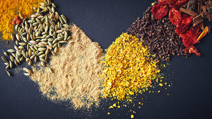 Collection, spices and seasoning in dark background for flavor, aroma and sensory appeal for creativity with culinary. Studio, condiment and herbs for cultural identity with clove, turmeric or powder