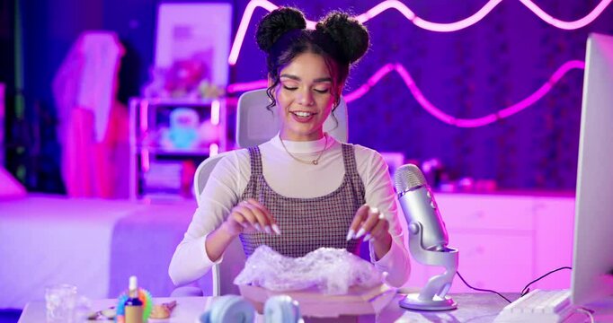 Unboxing, influencer and girl in podcast, home and talking to fans with subscription, social media and review. House, content creator and person, feedback and communication for product or advertising