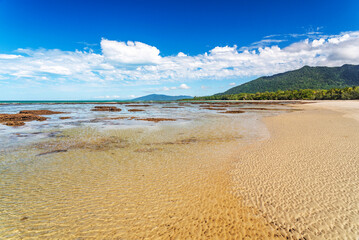 Picturesque tropical coastal sandy beach in Cape Tribulation, Queensland, Australia. Cape Tribulation is within Daintree National Park on Coral Sea.