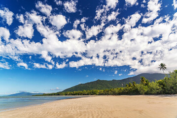 Picturesque tropical coastal sandy beach in Cape Tribulation, Queensland, Australia. Cape Tribulation is within Daintree National Park on Coral Sea.