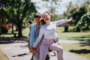 Fototapeta premium Three friends enjoying a bicycle ride together in a sunny park during the weekend